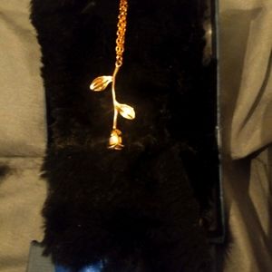 Rose gold necklace with a rose gold rose charm.